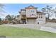 Exterior shot of home with a multi-level deck, driveway, and mature trees surrounding the property at 5141 Dixie Lake Rd, Union City, GA 30291