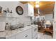 Well-lit kitchen showcasing white cabinets, marble countertops, tile backsplash and adjoining living area at 5141 Dixie Lake Rd, Union City, GA 30291