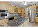 Spacious kitchen features stainless steel appliances, island cooktop, custom cabinets, and tile flooring at 5141 Dixie Lake Rd, Union City, GA 30291