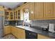 This kitchen features stainless steel appliances, double sinks, granite countertops, and custom cabinetry at 5141 Dixie Lake Rd, Union City, GA 30291
