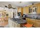 Bright kitchen features granite countertops, an island cooktop, custom cabinetry and stainless steel appliances at 5141 Dixie Lake Rd, Union City, GA 30291