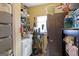 Functional laundry room with washer, dryer, shelving, storage, and cleaning supplies at 5141 Dixie Lake Rd, Union City, GA 30291