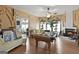 Open living room features a billiard table, fireplace, hardwood flooring, and lots of natural light at 5141 Dixie Lake Rd, Union City, GA 30291