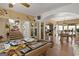 Spacious living room with billiard table, adjacent to the dining room and staircase, perfect for entertaining at 5141 Dixie Lake Rd, Union City, GA 30291