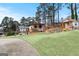 Charming backyard featuring two buildings, mature trees and green space at 5141 Dixie Lake Rd, Union City, GA 30291