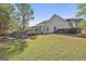 Backyard view featuring a wooden deck, hot tub, and lush greenery at 140 Pecan Ridge Dr, Fayetteville, GA 30215