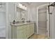 Well-lit bathroom with double vanity, granite countertop, and decorative mirror at 140 Pecan Ridge Dr, Fayetteville, GA 30215