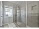 Modern bathroom featuring an all glass shower enclosure, tile work, and a large window at 140 Pecan Ridge Dr, Fayetteville, GA 30215