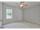 Cozy bedroom with neutral walls, carpet flooring, a ceiling fan, and a bright window at 140 Pecan Ridge Dr, Fayetteville, GA 30215