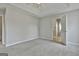 Bright bedroom with neutral walls, carpet, tray ceiling, and open ensuite bathroom at 140 Pecan Ridge Dr, Fayetteville, GA 30215