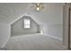 Attic bedroom with neutral walls, carpet flooring, and a bright window at 140 Pecan Ridge Dr, Fayetteville, GA 30215