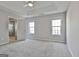 Bright bedroom with neutral walls, carpet, two windows, and an ensuite bathroom at 140 Pecan Ridge Dr, Fayetteville, GA 30215