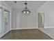 Bright dining room features ceramic tile floor, a modern light fixture, and sliding door access to the sunroom at 140 Pecan Ridge Dr, Fayetteville, GA 30215