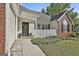 Charming front entrance with a decorative wreath, black door, and manicured landscaping at 140 Pecan Ridge Dr, Fayetteville, GA 30215