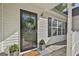 Inviting front porch featuring a decorative wreath, potted plants, and a welcome mat at 140 Pecan Ridge Dr, Fayetteville, GA 30215