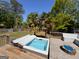 Backyard deck featuring a hot tub, a seating area, and lush palm trees at 140 Pecan Ridge Dr, Fayetteville, GA 30215