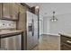 Open-concept kitchen features granite countertops, stainless steel appliances, and easy access to the sunroom and dining area at 140 Pecan Ridge Dr, Fayetteville, GA 30215