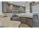 Stylish kitchen featuring granite countertops, stainless steel appliances, and dark cabinets providing a modern culinary space at 140 Pecan Ridge Dr, Fayetteville, GA 30215