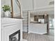 Open-concept design showcases a living room with a fireplace, built-in shelving, and views into the kitchen and sunroom at 140 Pecan Ridge Dr, Fayetteville, GA 30215