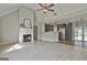 Bright open-concept living room featuring a fireplace, vaulted ceilings, and seamless kitchen access at 140 Pecan Ridge Dr, Fayetteville, GA 30215