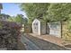 Backyard storage shed with double doors and a charming rustic design at 140 Pecan Ridge Dr, Fayetteville, GA 30215