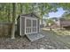 Backyard storage shed with double doors and a wooden ramp at 140 Pecan Ridge Dr, Fayetteville, GA 30215
