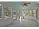Bright sunroom with white wood paneling, tile floors, and multiple windows overlooking the backyard at 140 Pecan Ridge Dr, Fayetteville, GA 30215