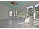 Bright sunroom with white wood paneling, tile floors, and multiple windows overlooking the backyard at 140 Pecan Ridge Dr, Fayetteville, GA 30215