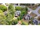 Aerial view of a beautiful home with a spacious backyard, screened porch and surrounded by lush greenery and mature trees at 102 Santolina Park, Peachtree City, GA 30269