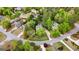Aerial view of a home nestled among lush trees and greenery, featuring a well-manicured lawn and circular driveway at 102 Santolina Park, Peachtree City, GA 30269