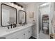 Updated bathroom featuring double sinks, modern lighting, and a separate toilet room at 102 Santolina Park, Peachtree City, GA 30269