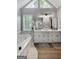 Open and bright bathroom featuring double vanities, a tub, and a window at 102 Santolina Park, Peachtree City, GA 30269