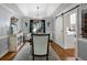 Elegant dining room featuring tray ceilings, stylish chandelier and barn door access at 102 Santolina Park, Peachtree City, GA 30269
