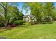 Beautiful two-story home with a well-maintained lawn and mature trees at 102 Santolina Park, Peachtree City, GA 30269