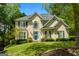 Stunning two-story home featuring a bright blue front door and manicured landscaping at 102 Santolina Park, Peachtree City, GA 30269