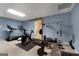 Home gym featuring various exercise equipment, including a treadmill and weight rack at 102 Santolina Park, Peachtree City, GA 30269