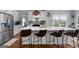 Modern kitchen with a large center island, stainless steel appliances, and stylish breakfast bar seating at 102 Santolina Park, Peachtree City, GA 30269