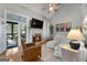 Bright living room with a fireplace, comfortable seating, and a seamless transition to the outdoor area at 102 Santolina Park, Peachtree City, GA 30269