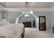 Comfortable primary bedroom with neutral paint colors and arched window at 102 Santolina Park, Peachtree City, GA 30269