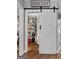 Well-stocked pantry with a sliding barn door, offering ample storage and easy access to kitchen essentials at 102 Santolina Park, Peachtree City, GA 30269