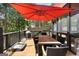 Relax on the screened-in porch complete with red umbrella providing shade for the table and chairs at 102 Santolina Park, Peachtree City, GA 30269