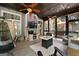 This is a spacious screened-in porch with a fireplace and ceiling fans, perfect for relaxing and entertaining in any weather at 102 Santolina Park, Peachtree City, GA 30269