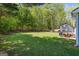 Large, grassy backyard featuring mature trees and a well-maintained lawn, ideal for recreation at 195 Riverbend Dr, Covington, GA 30014
