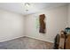 Empty bedroom with neutral walls, gray carpet, and a window that provides natural light at 195 Riverbend Dr, Covington, GA 30014
