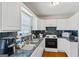 Functional kitchen with white cabinets, sleek appliances, and a window at 195 Riverbend Dr, Covington, GA 30014