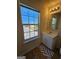 Bathroom with vanity, sink, mirror, and window overlooking neighborhood at 6806 Blackstone Pl # 12, Mableton, GA 30126
