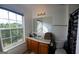 Bright bathroom with a window view, wooden cabinets, and a combination of shower and bathtub at 6806 Blackstone Pl # 12, Mableton, GA 30126