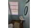 Powder room with pedestal sink, oval mirror, and natural light from window at 6806 Blackstone Pl # 12, Mableton, GA 30126