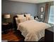 Bedroom with large bed, side table, and neutral colors at 6806 Blackstone Pl # 12, Mableton, GA 30126