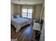 Cozy bedroom with hardwood floors, a bright window, and a modern workspace at 6806 Blackstone Pl # 12, Mableton, GA 30126